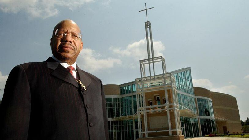 Rev. Jasper Williams Jr, Pastor of Salem Bible Church East is standing in front of the newly built church located on Hillandale .