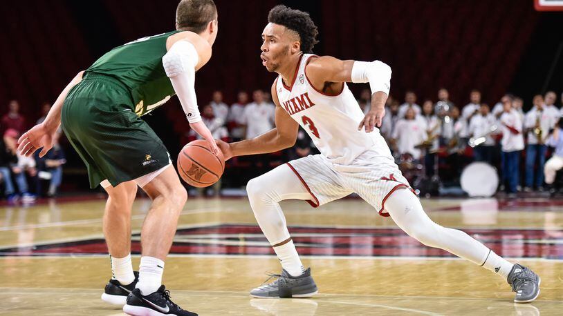Miami’s Jalen Adaway dribbles as he is defended by Wright State’s Grant Benzinger during their game Tuesday, Nov. 14 at Millett Hall on the Miami University Campus in Oxford. NICK GRAHAM/STAFF