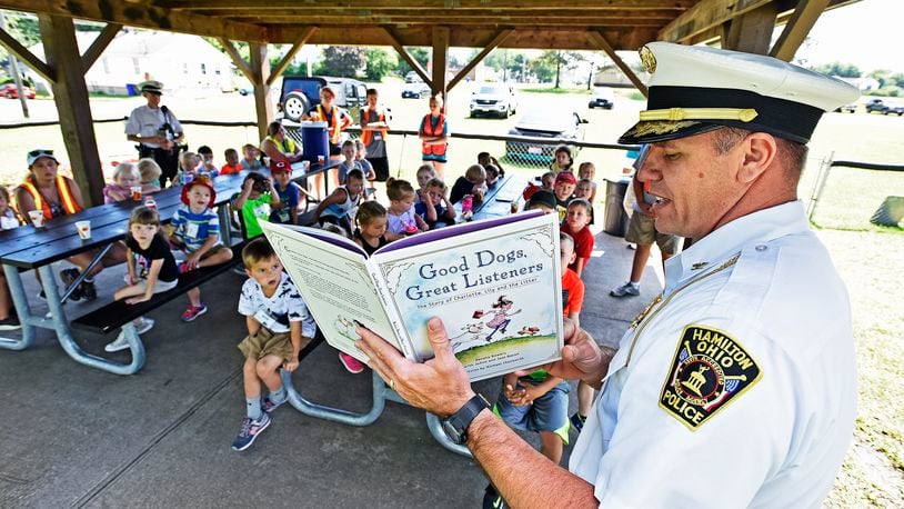 Hamilton Police Chief Craig Bucheit reads a book to kids at the Greater Hamilton Safety Council Safety Town Thursday, June 28 in Hamilton. Safety Town, in its 46th season, is an interactive way for four and five year old children to experience safety lessons in a way that is engaging and enjoyable. NICK GRAHAM/STAFF  