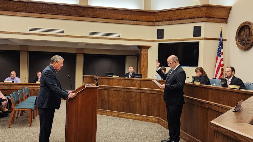 K. Philip Callahan, left, Monroe's law director, swears in Larry Lester as city manager during a recent City Council meeting. SUBMITTED PHOTO