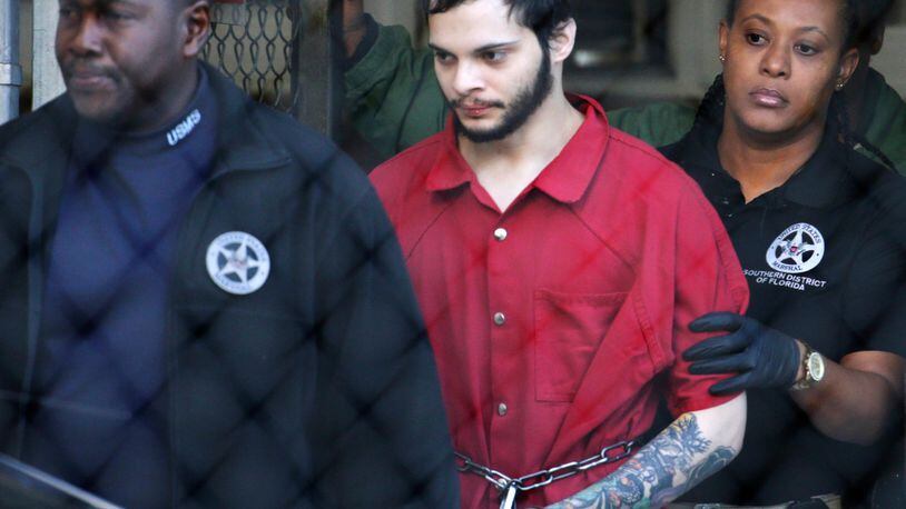 In this Jan. 30, 2017, file photo, Esteban Santiago, center, is led from the Broward County jail for an arraignment in federal court in Fort Lauderdale. Santiago received five life terms plus an additional 120 years in prison at his sentencing Friday.