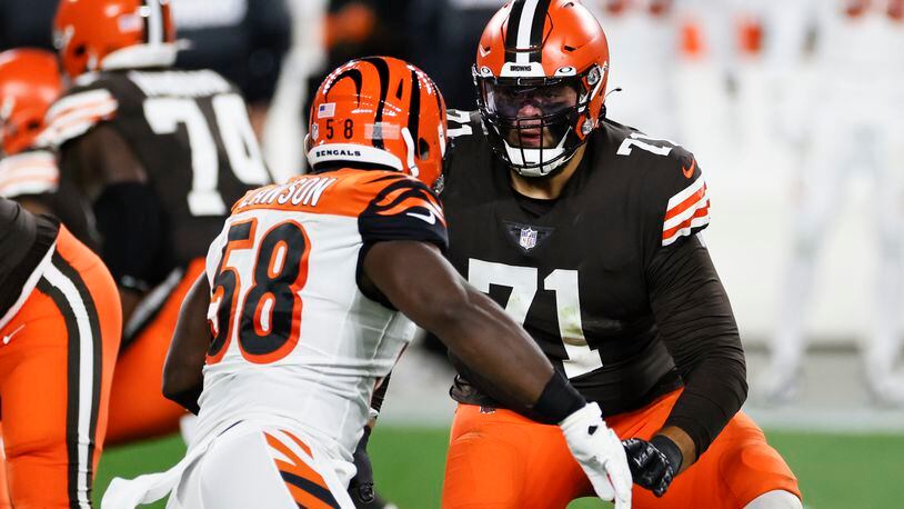 Cleveland Browns offensive tackle Jedrick Wills (71) plays against Cincinnati Bengals defensive end Carl Lawson (58) during the first half of an NFL football game, Thursday, Sept. 17, 2020, in Cleveland. (AP Photo/Ron Schwane)