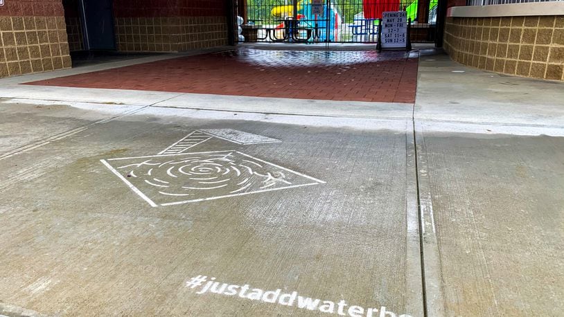 Just Add Water, an innovative sidewalk art installation in Butler County, Ohio combines art with hydrophobic paint to reveal art when it rains. The art is invisible when dry, but with the help of some water art it suddenly appears on sidewalks. The artwork is interactive and can be found at eight different locations in Butler County including Liberty Center, Marcum Park, Fitton Center for Creative Arts, the Square @ Union Centre, Oxford Aquatic Center, Furfield Dog Park, Jungle Jim’s International Market, and Governor’s Square. KATHRYN TRUCCO / CONTRIBUTED