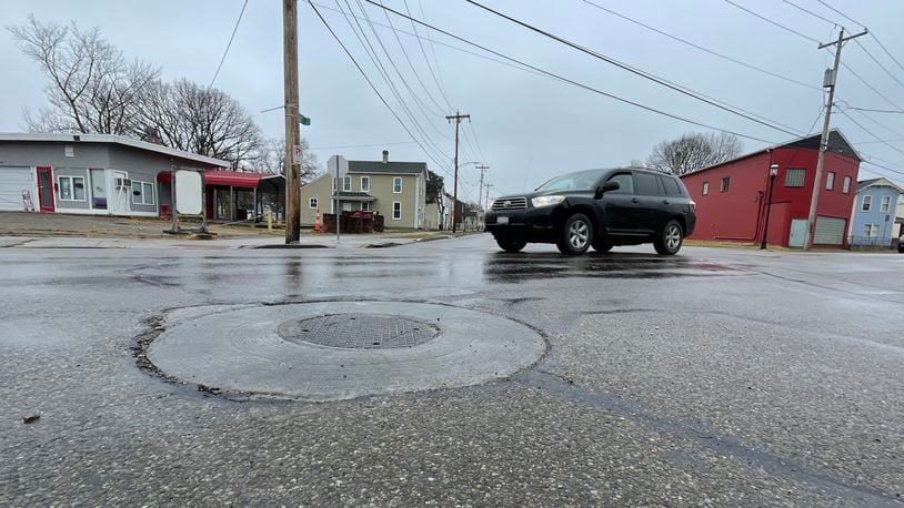 The city of Hamilton since 2019 has been strengthening its manhole covers to provide a longer lasting street surfaces. MICHAEL D. PITMAN/STAFF