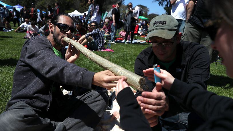 A marijuana user attempts to light an oversized joint during a 420 Day celebration on “Hippie Hill” in Golden Gate Park on April 20, 2018 in San Francisco, California. In the first year that marijuana is legal for recreational use in California, thousands of marijuana enthusiasts gathered in Golden Gate Park to celebrate 420 day, the de facto holiday for marijuana advocates, with large gatherings and “smoke outs” in many parts of the United States. JUSTIN SULLIVAN / GETTY IMAGES