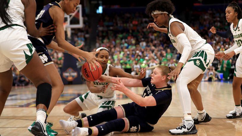 Notre Dame freshman Abby Prohaska (12) attempts to pass the ball to teammate Mikayla Vaughn (30) during Sunday night’s NCAA championship game against Baylor at Amalie Arena in Tampa, Fla. Baylor won the title 82-81. MIKE EHRMANN/GETTY IMAGES