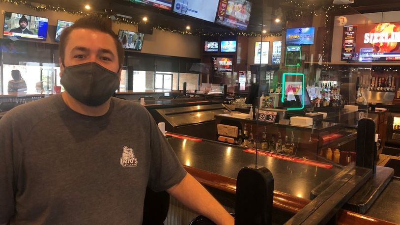 Bob MacKendrick, co-owner and general manager of Berd's Grill & Bar in Fairfield, is excited about customers watching NCAA Tournament games this year after the tourney was cancelled last year due to the coronavirus pandemic. RICK McCRABB/STAFF
