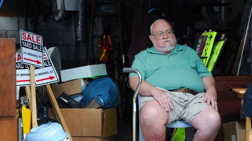 Willie Davis, a U.S. Navy veteran who is dying from cancer, sits in his garage among many of his belongings, which he's trying to sell to help pay for his own funeral, Wednesday, Sept. 26, 2018, in Johnstown, Pa. (John Rucosky/Tribune-Democrat via AP)