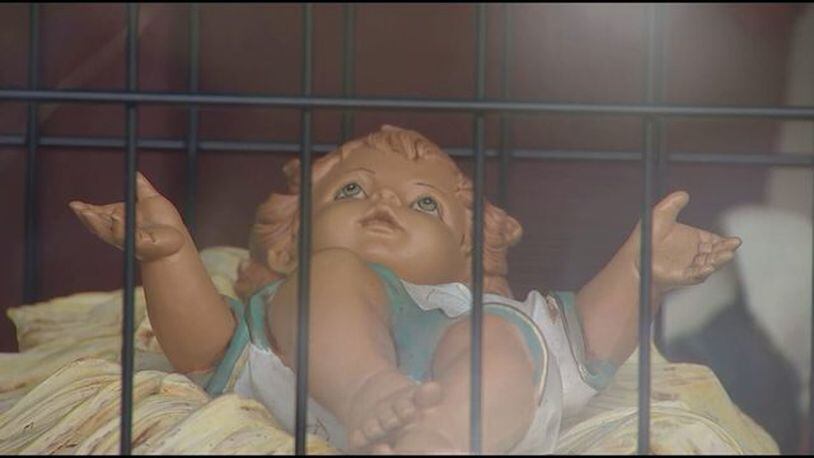 A church in Dedham, Massachusetts, is displaying a controversial nativity scene again this year showing the baby Jesus in a cage and questioning the phrase 'Peace on Earth?' to spark conversation about Trump administration policies.