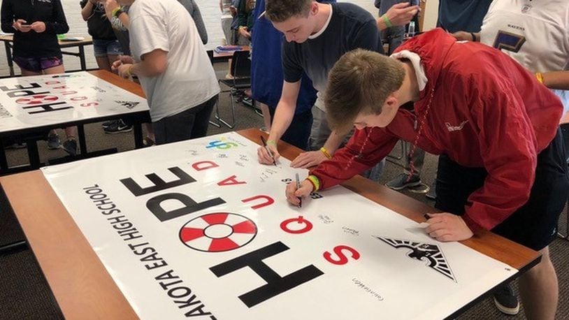 Lakota East High School students sign a Hope Squad banner last year to symbolize their commitment to offering hope to their peers who may be in distress. SUBMITTED PHOTO