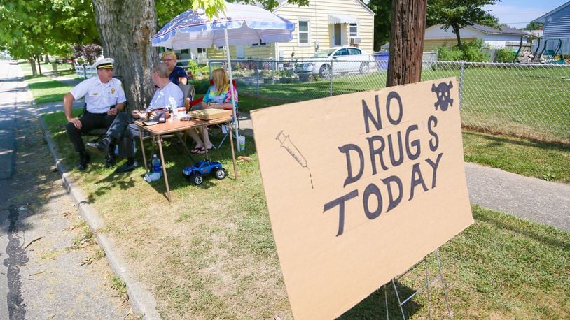 The “No Drugs Today” campaign by Parkamo Avenue resident Denny Matheny helped spur Hamilton’s East End neighborhood to organize. During his outdoor sit-in last summer, Matheny, who was angered about drug dealing in the neighborhood, was joined throughout the day by various neighbors, family members, and Hamilton Police Chief Craig Bucheit. GREG LYNCH / STAFF