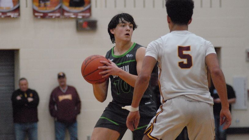 Badin sophomore Nathan Lindesmith (10) is guarded by Ross junior Riley Caldwell (5) during their game on Saturday night at Ross. Chris Vogt/CONTRIBUTED