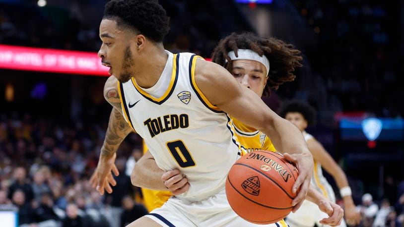 Toledo guard Ra'Heim Moss (0) drives against Kent State guard Jalen Sullinger during the second half of an NCAA college basketball game for the championship of the Mid-American Conference Tournament, Saturday, March 11, 2023, in Cleveland. (AP Photo/Ron Schwane)