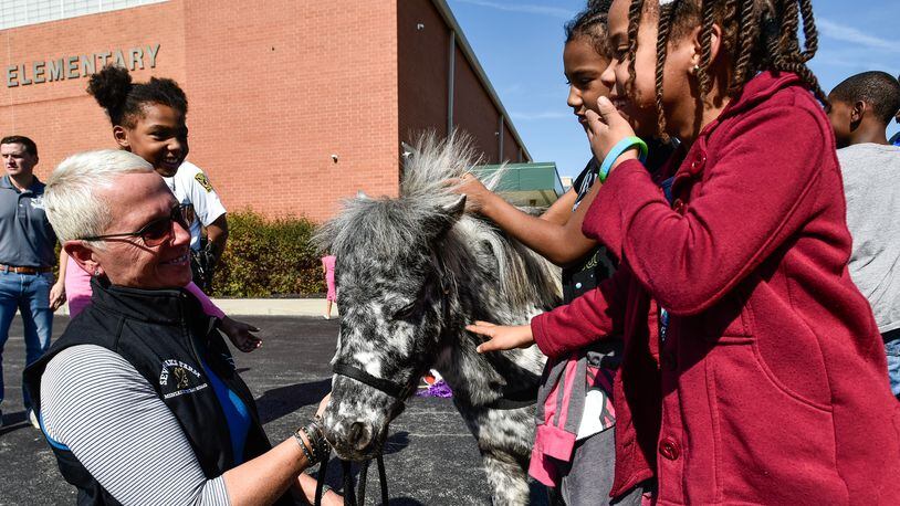Lisa Moad, with Seven Oaks Farm, shows off a miniature horse named Patches during an anti-bullying program at Riverview Elementary School Friday, Oct. 20, 2017 in Hamilton. NICK GRAHAM/STAFF