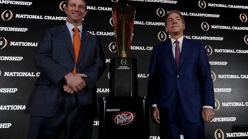 Clemson head coach Dabo Swinney and Alabama head coach Nick Saban pose with the championship trophy during a news conference for the NCAA college football playoff championship game Sunday, Jan. 8, 2017, in Tampa, Fla. (AP Photo/David J. Phillip)
