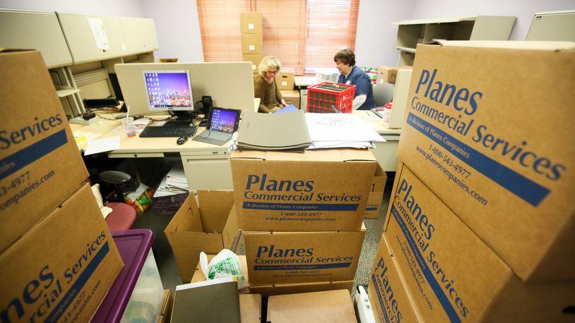 Candace Swan and Cheryl Guendelsberger pack up the Hamilton satellite office of the Butler County Board of Developmental Disabilities on March 9 in preparation of their move to the office on Liberty-Fairfield Road. GREG LYNCH / STAFF