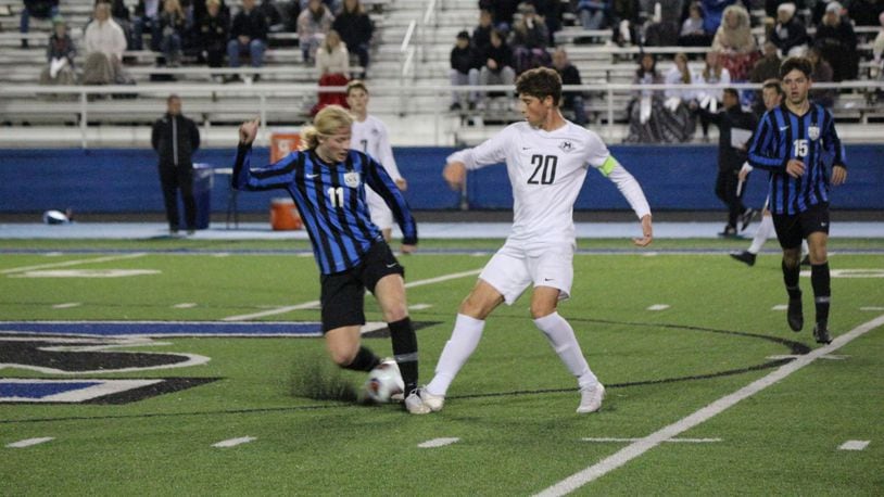 Lakota East’s Ethan Seppi (20) battles Olentangy Liberty’s Jaggar Brooker for possession during a Division I state semifinal match on Wednesday, Nov. 6. Greg Billing/CONTRIBUTED