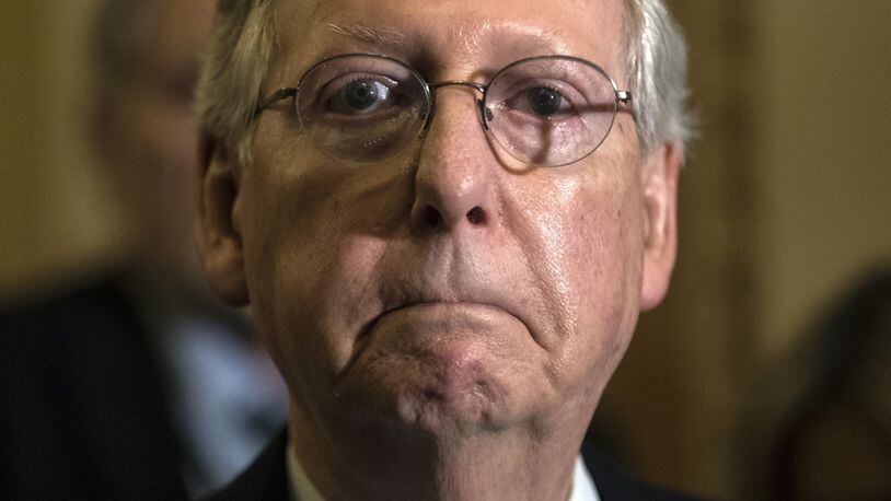 In this June 27, 2017, photo, Senate Majority Leader Mitch McConnell, R-Ky., tells reporters he is delaying a vote on the Republican health care bill at the Capitol in Washington. Congressional Republicans are stymied over health care. But after seven years of promising to repeal and replace former President Barack Obama’s law, they risk political disaster if they don’t deliver. (AP Photo/J. Scott Applewhite)