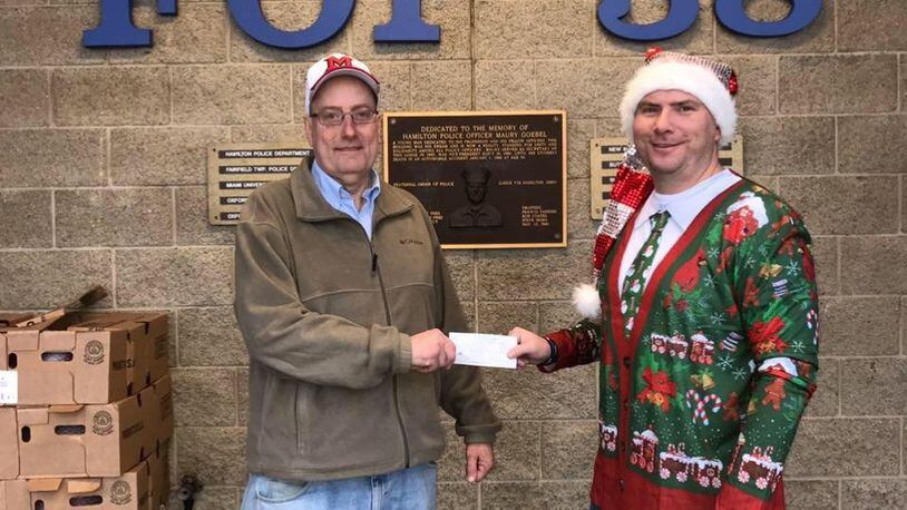 The Hamilton Fraternal Order of Police Lodge #38 conducted its annual Christmas Caravan on Saturday as officers from area police departments delivered gifts to needy families. Mayor Patrick Moeller (left) with Hamilton police Sgt. Brian Robinson just before a caravan of officers left to deliver the gifts. CONTRIBUTED