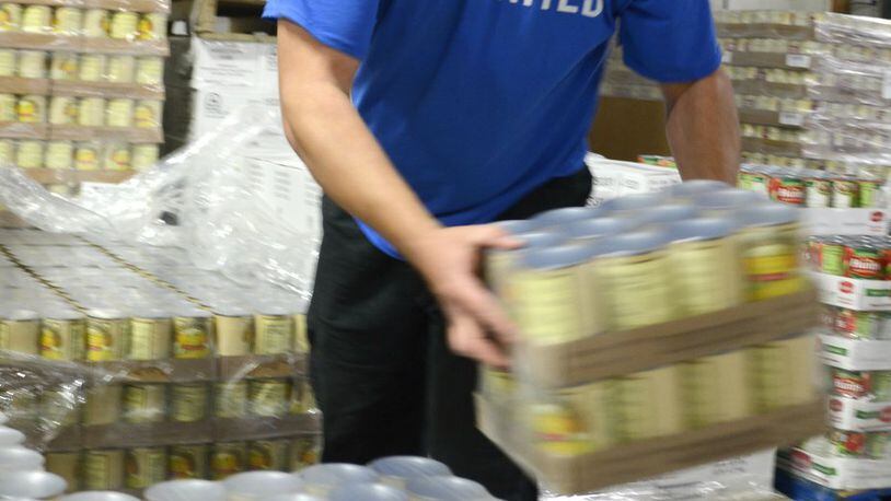 Shared Harvest Foodbank in Fairfield has seen its number of donors drop every year since 2011. For every $1 donated, it can provide seven meals. Pictured is Nathan Hoskins, the warehouse manager at Shared Harvest, loading up a pallet of canned food.