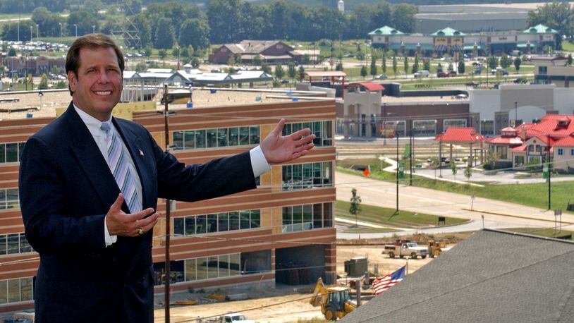 In this 2005 file photo, Joe Hinson, the West Chester-Liberty Chamber of Commerce CEO, stands with open arms in front of a still young yet booming Union Centre Boulevard. The West Chester interchange turns 20 this year. STAFF FILE/2005