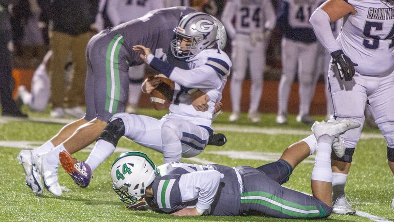Badin's Logan Neu and Jackson Martin (44) sack Granville quarterback Carsyn Crouch in the first half of Friday night's 14-0 state semifinal win. Jeff Gilbert/CONTRIBUTED