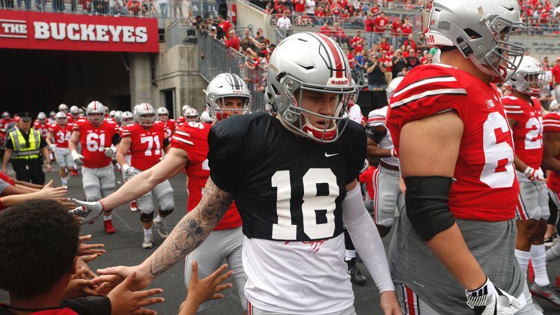 Ohio State players, including Tate Martell (18), prepare to take the field before the spring game on Saturday, April 14, 2018, at Ohio Stadium in Columbus. David Jablonski/Staff