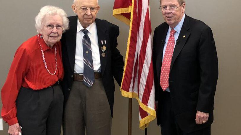 Ralph G. Rumsey (middle) was presented with a Prisoner of War Medal by U.S. Senator Johnny Isakson, on right, as his wife Ruby and other family and friends looked on. (Photo: U.S. Senator Johnny Isakson’s Office)