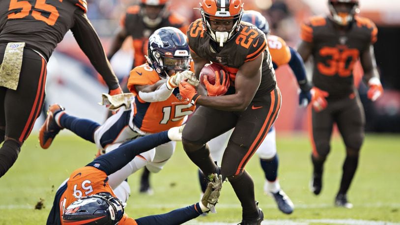 DENVER, CO - NOVEMBER 3: Montreal Hilliard #25 of the Cleveland Browns runs the ball and is hit by Juwann Winfree #15 and Malik Reed #59 of the Denver Broncos during the first half at Broncos Stadium at Mile High on November 3, 2019 in Denver, Colorado. (Photo by Wesley Hitt/Getty Images)