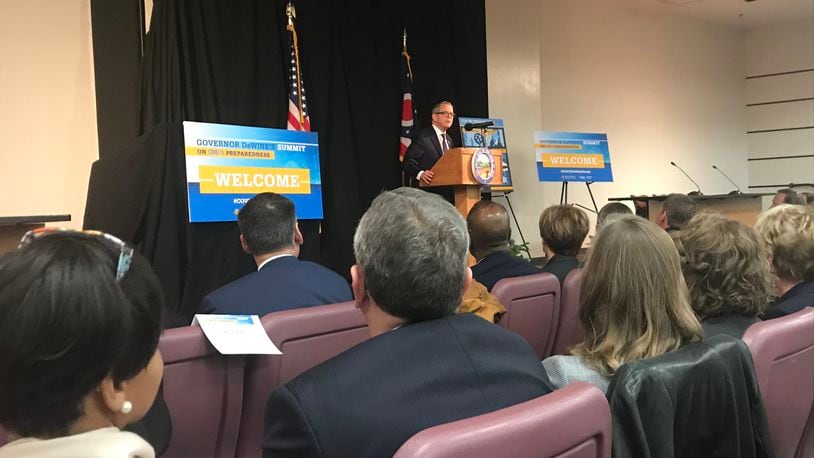 Gov. Mike DeWine addresses a crowded room gathered in Columbus of public health officials and other leaders working to remain repared in the wake of the coronavirus outbreak in other parts of the world. KAITLIN SCHROEDER