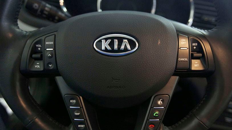 FILE - The Kia logo brands a steering wheel inside of a Kia car dealership in Elmhurst, Ill., Oct. 5, 2012. (AP Photo/Nam Y. Huh, File)