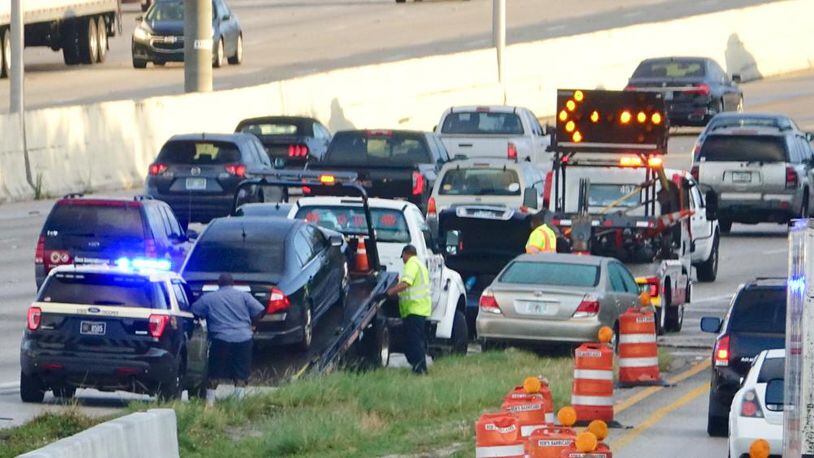 Stranded motorists on northbound I-95 are assisted after 30 vehicles got flat tires Monday morning, April 23, 2018 due to metal debris in the road. (Photo: Lannis Waters/The Palm Beach Post)
