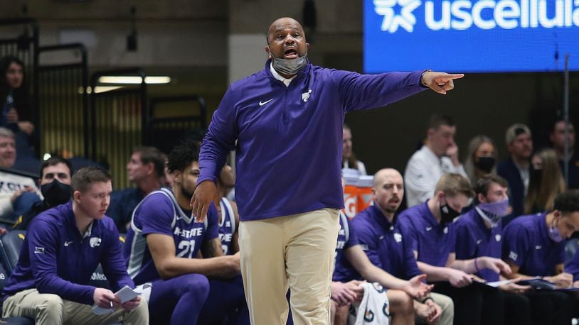Kansas State assistant coach Jermaine Henderson reacts during the second half of an NCAA college basketball game against West Virginia in Morgantown, W.Va., Saturday, Jan. 8, 2022. (AP Photo/Kathleen Batten)