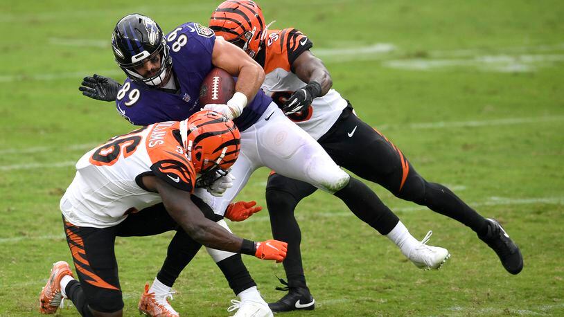 Baltimore Ravens tight end Mark Andrews (89) is tackled by Cincinnati Bengals strong safety Shawn Williams (36) and linebacker Akeem Davis-Gaither during the first half of an NFL football game, Sunday, Oct. 11, 2020, in Baltimore. (AP Photo/Nick Wass)