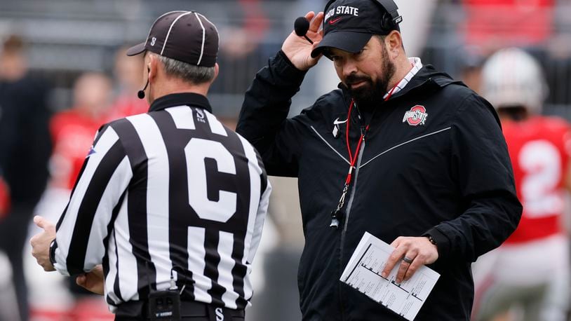 FILE — Ohio State head coach Ryan Day, right, talks with a referee during an NCAA college spring football game in this April 16, 2022 file photo, in Columbus, Ohio. The pain of Ohio State's loss to Michigan last season remains for the Buckeyes, who can't wait to try to avenge the loss. (AP Photo/Jay LaPrete, File)