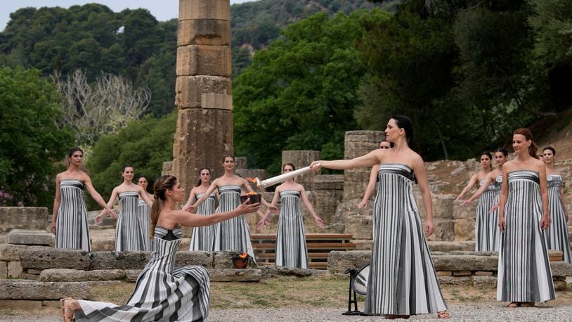 Performers take part in the official ceremony of the flame lighting for the Paris Olympics, at the Ancient Olympia site, Greece, Tuesday, April 16, 2024. The flame will be carried through Greece for 11 days before being handed over to Paris organizers on April 26. (AP Photo/Thanassis Stavrakis)