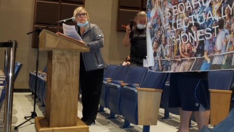 Among the anti-mask speakers at Hamilton school board's recent meeting was one who brought a photo poster reading: "This Board Is Intellectually Dishonest." A Hamilton Police officer working security took the poster and a man who was holding it was ordered by the officer to leave the building, according to the man. (Provided Photo\Journal-News)