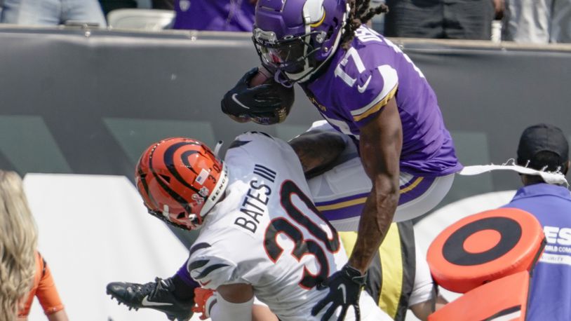 Minnesota Vikings wide receiver K.J. Osborn (17) tries to go over Cincinnati Bengals free safety Jessie Bates (30) as he runs after making a catch in the first half of an NFL football game, Sunday, Sept. 12, 2021, in Cincinnati. (AP Photo/Jeff Dean)