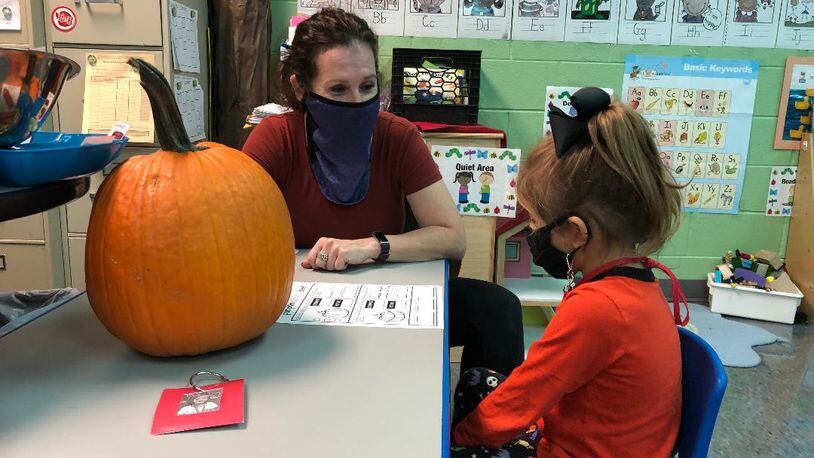 Jill Wuebker, a preschool teacher at Clark Early Learning Center in Springfield, works with student Juniper Schneider. Being back with her students is helping Wuebker overcome her bout with breast cancer, which she discovered last winter. BRETT TURNER/CONTRIBUTED