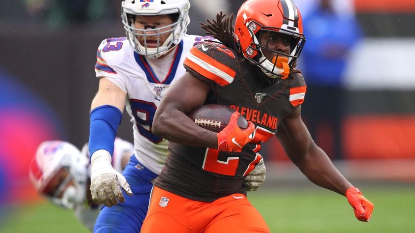 CLEVELAND, OHIO - NOVEMBER 10: Kareem Hunt #27 of the Cleveland Browns runs for a first down in front of Trent Murphy #93 of the Buffalo Bills during the second half at FirstEnergy Stadium on November 10, 2019 in Cleveland, Ohio. Cleveland won the game 19-17. (Photo by Gregory Shamus/Getty Images)