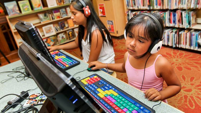 Children use the early learning stations at the Hamilton Lane Library. STAFF FILE PHOTO