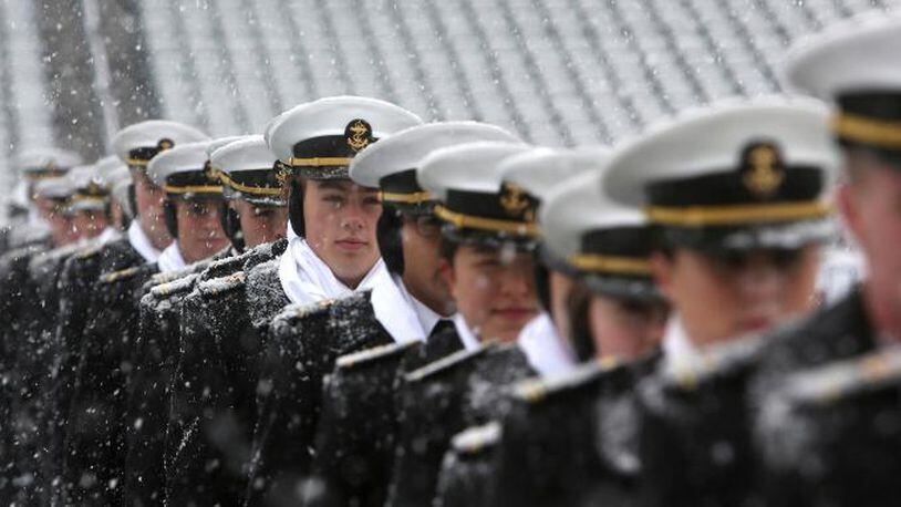Navy midshipman practice a formation as snow falls before the start of the at the 118th meeting of the annual Army-Navy football game Saturday Dec. 9, 2017 in Philadelphia. (AP Photo/Jacqueline Larma)