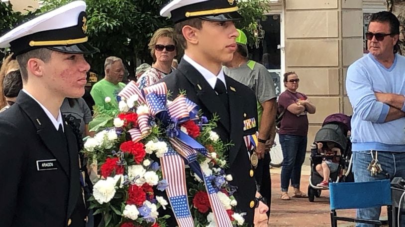 Two members of the Hamilton High School Junior Naval ROTC prepare to carry the wreath to the steps of Soldiers, Sailors and Pioneers Monument in Hamilton on Memorial Day 2021. RICK McCRABB/STAFF FILE PHOTO