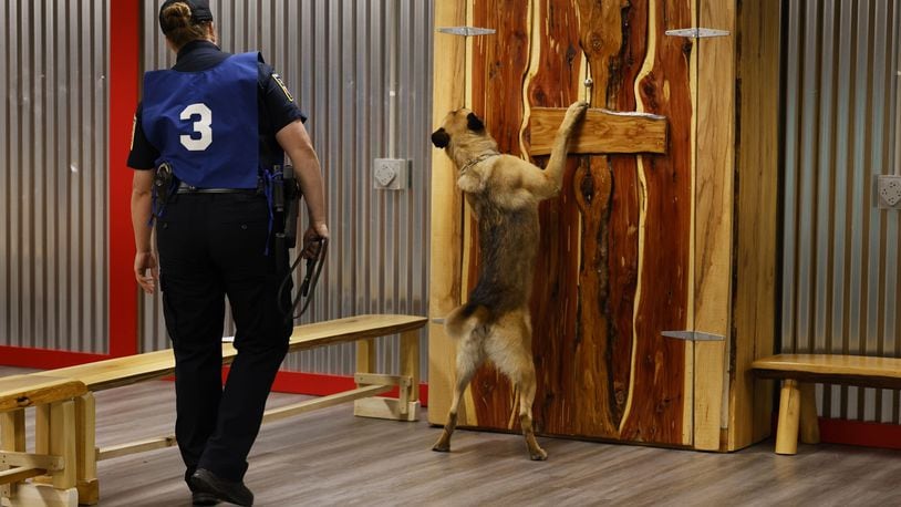 Middletown Police officer Lindsey Schwarber and Belgian Malinoir partner, Maverick, search for narcotics during the United States Police Canine Association region 5 trials Monday, May 16, 2022 at Berachah Church in Middletown. NICK GRAHAM/STAFF