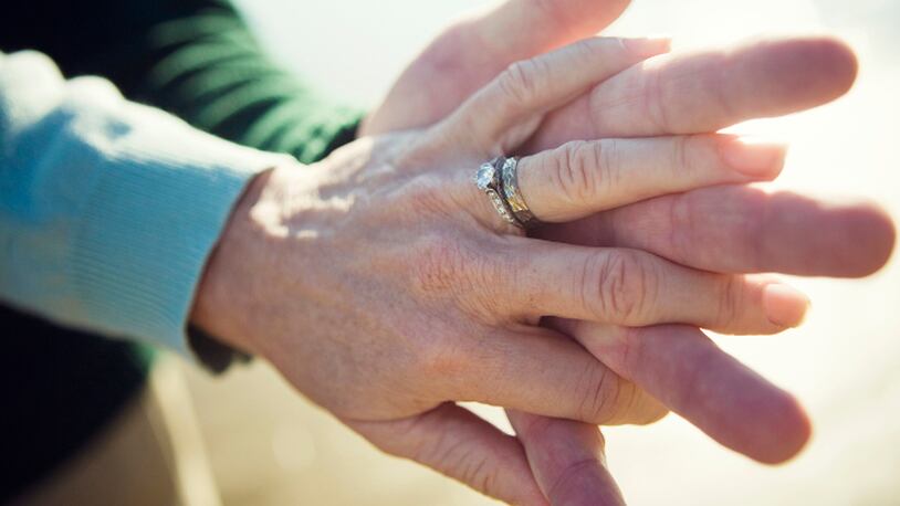Senior couple holding hands (stock photo).