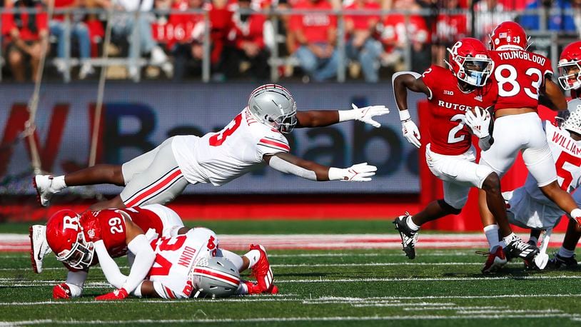 Rutgers wide receiver Aron Cruickshank (2) runs away from Ohio State linebacker Teradja Mitchell (3)  during an NCAA college football game, Saturday, Oct. 2, 2021, in Piscataway, N.J. (AP Photo/Noah K. Murray)