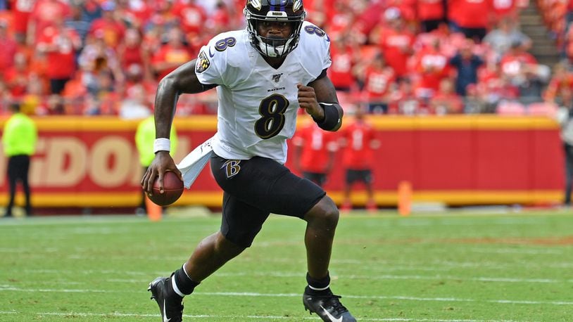 KANSAS CITY, MO - SEPTEMBER 22: Quarterback Lamar Jackson #8 of the Baltimore Ravens scrambles to the outside against the Kansas City Chiefs during the second half at Arrowhead Stadium on September 22, 2019 in Kansas City, Missouri. (Photo by Peter Aiken/Getty Images)