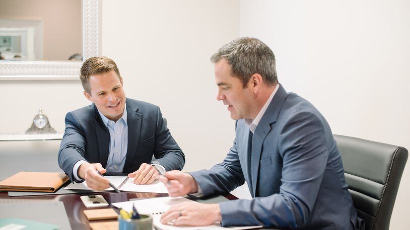 Dan Johnson, chief executive officer and a wealth adviser at Birchcreek Wealth Management in Miami Township, discusses financial planning with Matt Will, a wealth adviser at Birchcreek. CONTRIBUTED