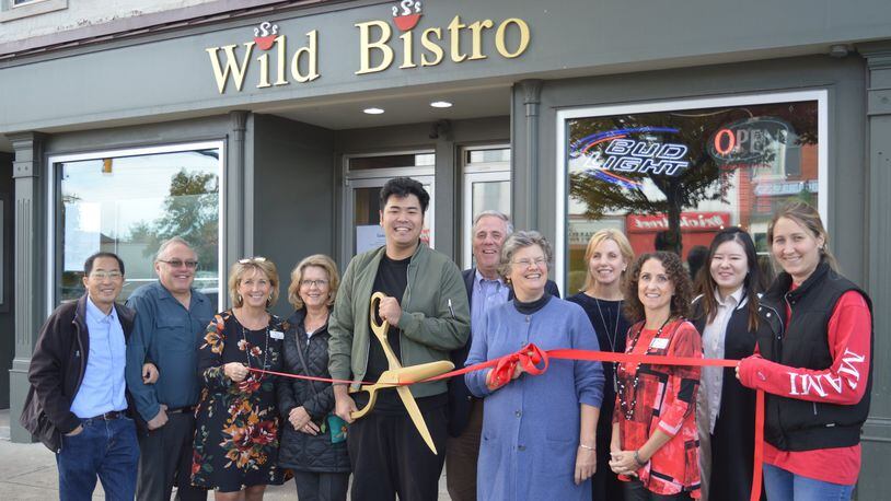 Wild Bistro became the second Asian restaurant to join the Oxford Chamber of Commerce recently and Tuesday was welcomed with the ceremonial ribbon-cutting event in front of their High Street location. Members of the chamber and restaurant pose with Joseph Ma holding the large scissors. CONTRIBUTED/BOB RATTERMAN
