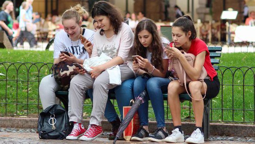 File photo of teens using smartphones.
